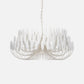 Modern chandelier with white glass shades on a light gray background