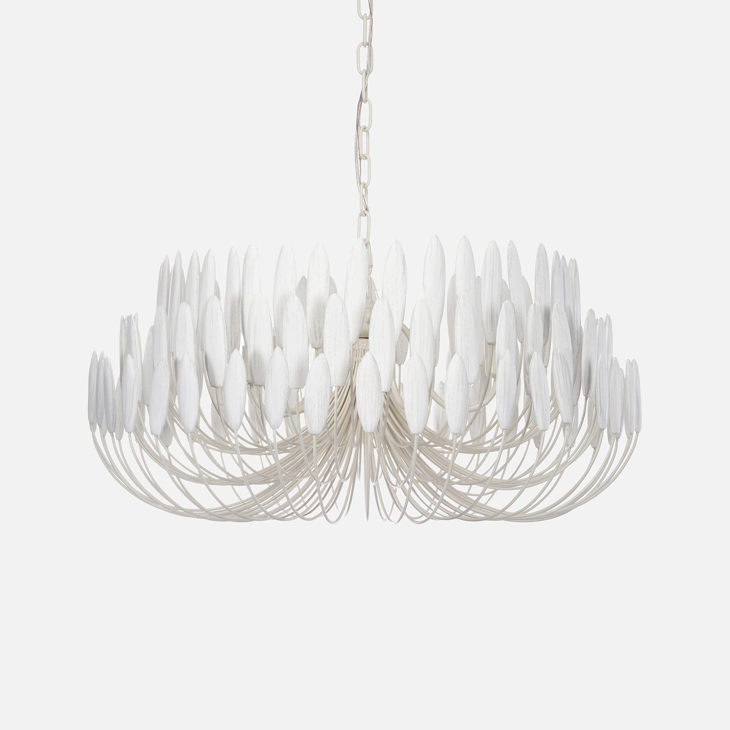 Modern chandelier with white glass shades on a light gray background