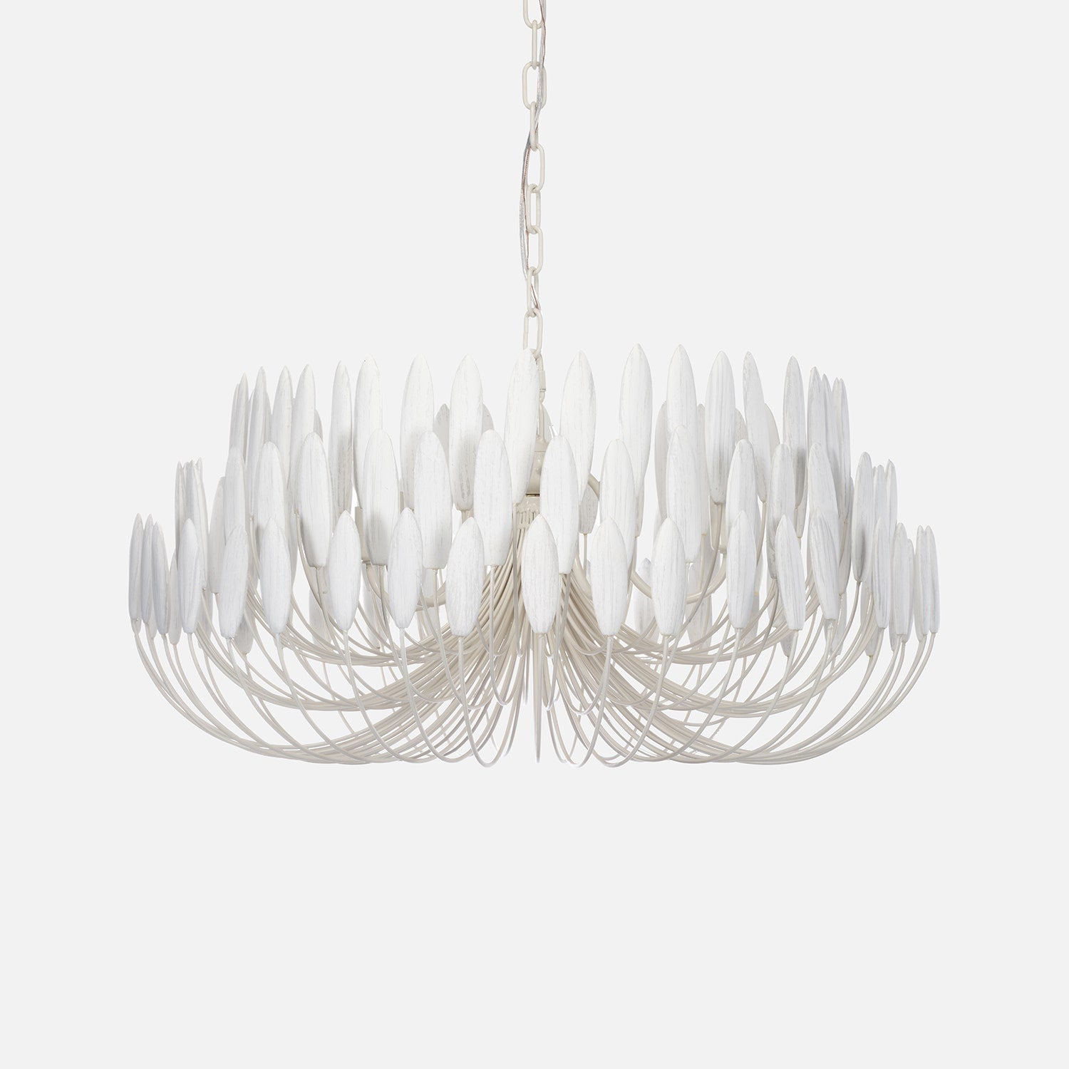 Modern chandelier with white glass shades on a light gray background