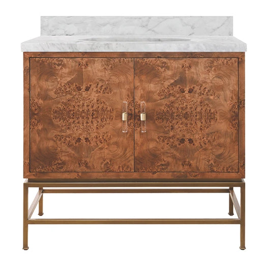 A two-door bathroom vanity cabinet with a rich copper-brown burl wood patterned finish, a white marble countertop, and a gold-finished metal frame and handles, shown against a solid white background.