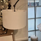 White lamp with a beige shade in a store setting
