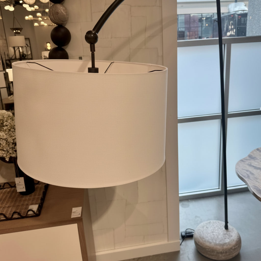 White lamp with a beige shade in a store setting