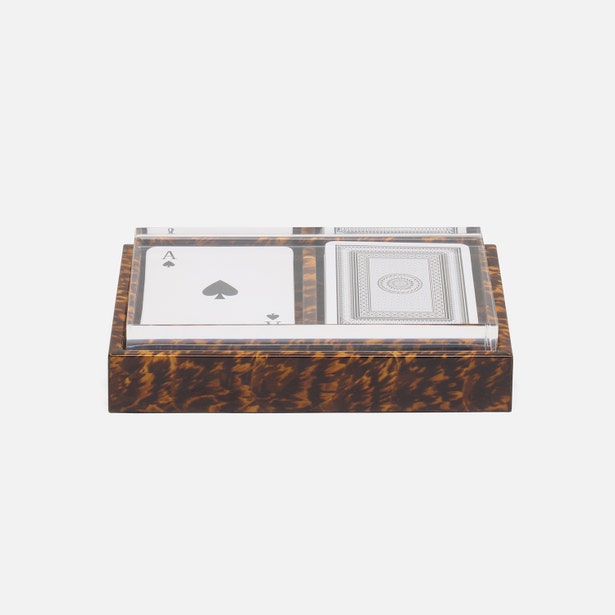 Playing cards with a tortoiseshell case on a white background