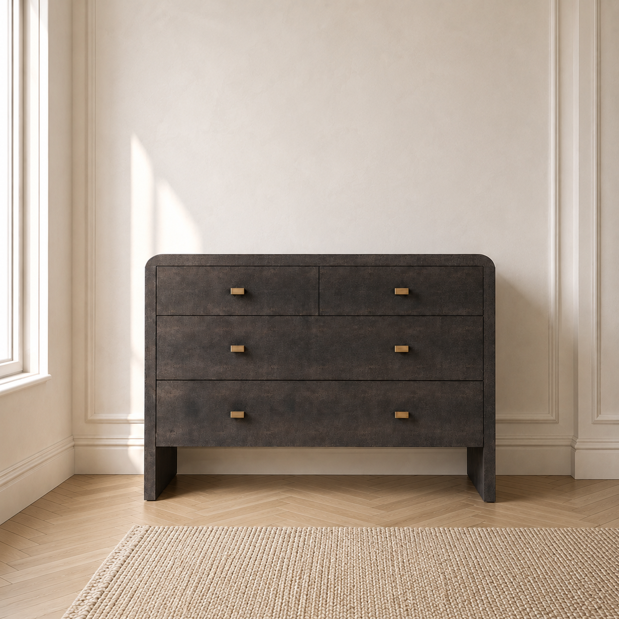 A dark mushroom faux shagreen chest of drawers with three drawers and small gold pull handles, set against a cream-colored wall in a room with light wood floors and a woven rug.