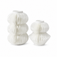 Two white ceramic decorative vases with a pleated, accordion-like textured design, one standing upright and one sitting upright, on a seamless white background.