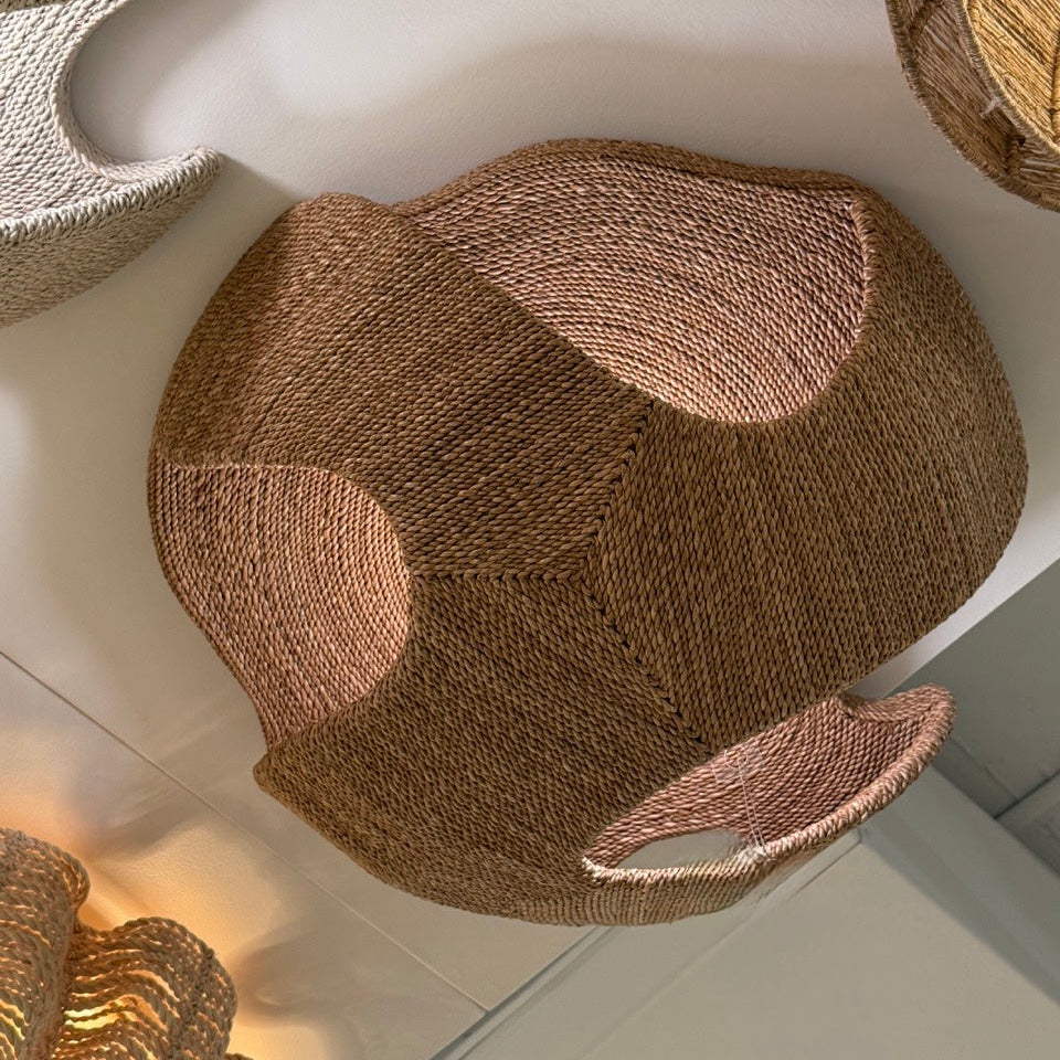 Woven basket with a unique design on a white surface