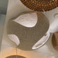 Woven stools with a textured surface on a light-colored floor.