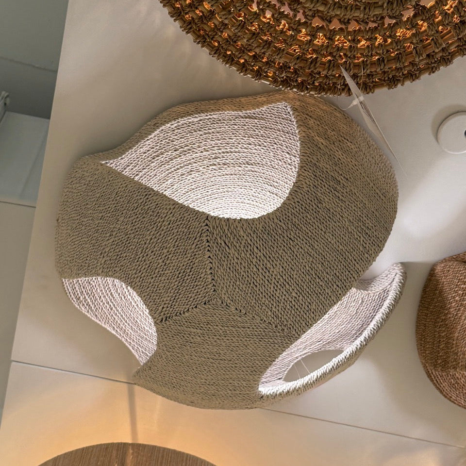Woven stools with a textured surface on a light-colored floor.