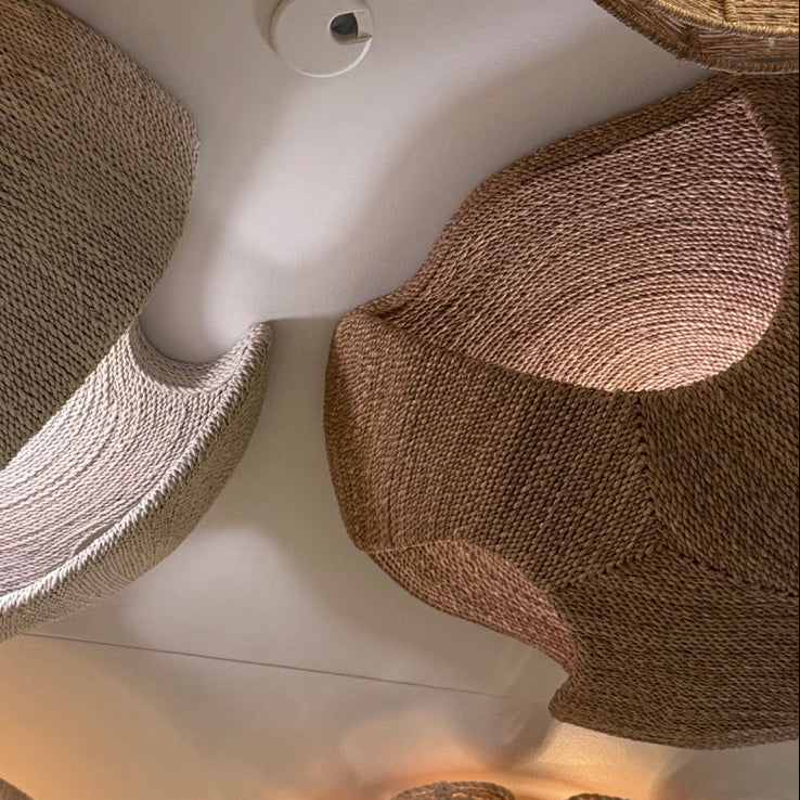 Close-up of decorative lampshades with a brand label in the foreground.