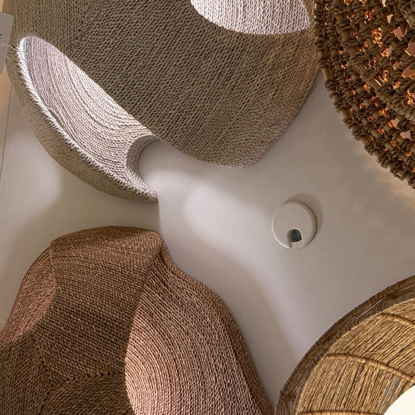 Close-up of decorative lampshades with a brand label in the foreground.