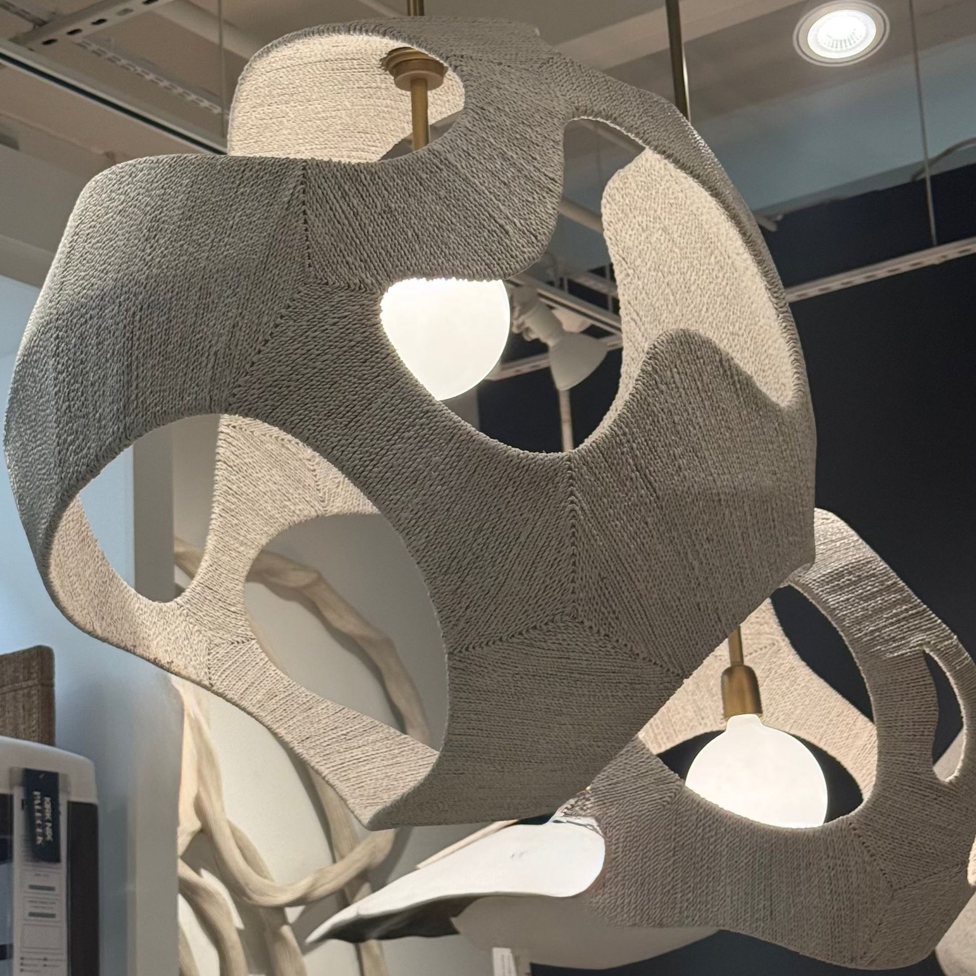 Modern chandelier with geometric design in a showroom setting