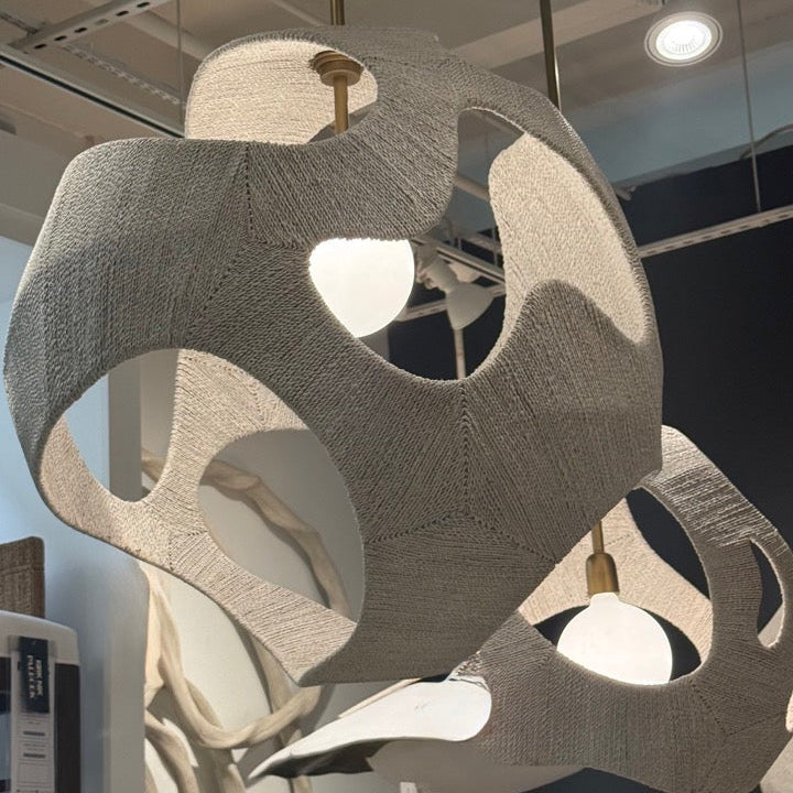 Modern chandelier with geometric design in a showroom setting