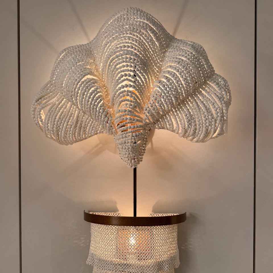 Decorative ceiling light fixture with intricate design on a neutral background