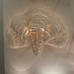 Decorative wall light fixture with a cloud-like design on a neutral background