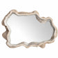 An organic-shaped wall mirror with a textured, wavy frame in a distressed silver and beige finish, shown against a plain white background.