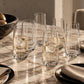 Dune Clear Glass Tumblers set out on a marble table set