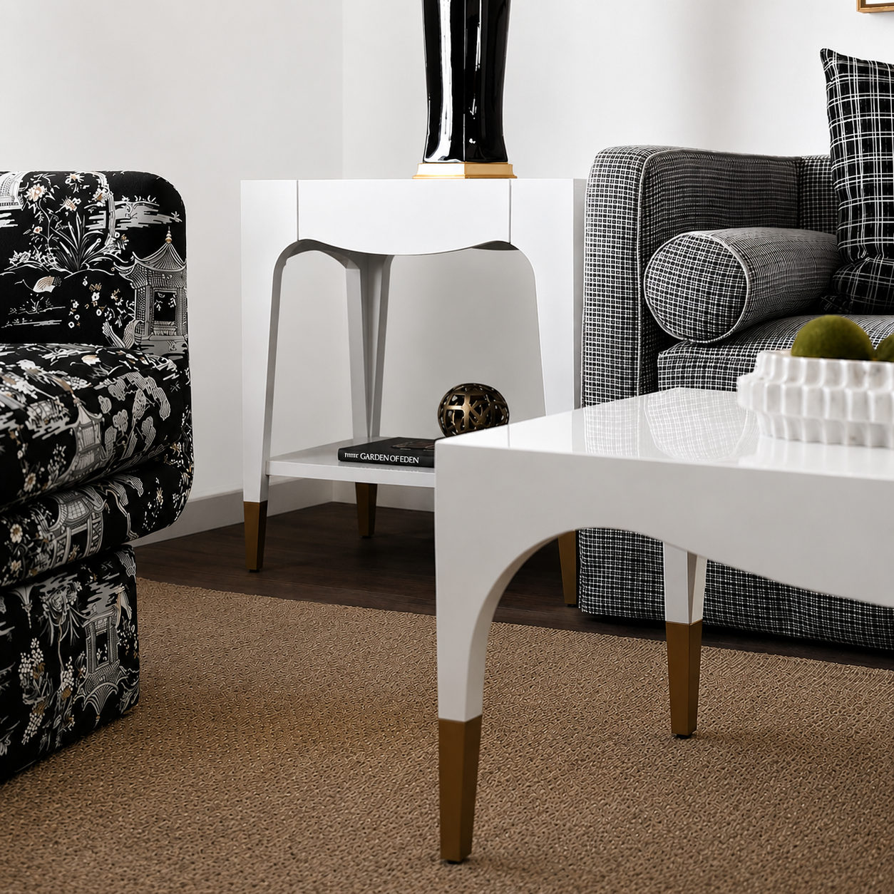 Modern living room with a white coffee table, patterned armchair, and plaid sofa.