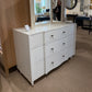 White dresser with mirror in a showroom setting
