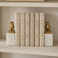 2 owl bookends gold leaf and marble holding up either side of a stack of decorative neutral books