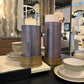 Decorative vases and bowls on a table with a blurred store interior in the background