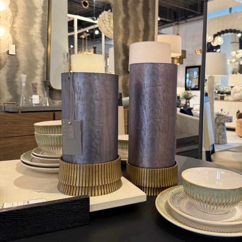 Decorative vases and bowls on a table with a blurred store interior in the background