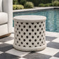 Decorative outdoor side table with lattice pattern on a checkered patio by a pool.