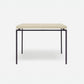 Rectangular table with a beige top and black metal legs on a white background