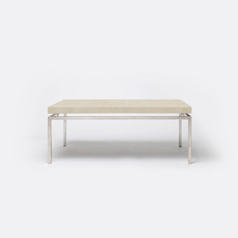 A rectangular coffee table with a light beige textured top and a slim silver metal frame, shown against a plain white background.