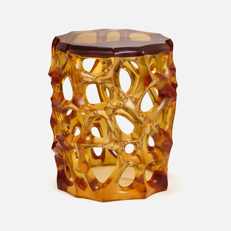 Hexagonal amber-colored stool with a textured surface on a white background