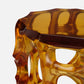 Amber-colored glass stool on a white background