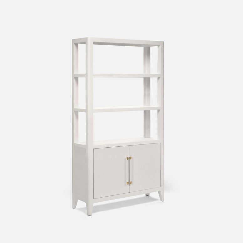 A tall white bookcase with four open shelves and two cabinet doors at the bottom, featuring slim gold-toned handles, shown on a light gray background.