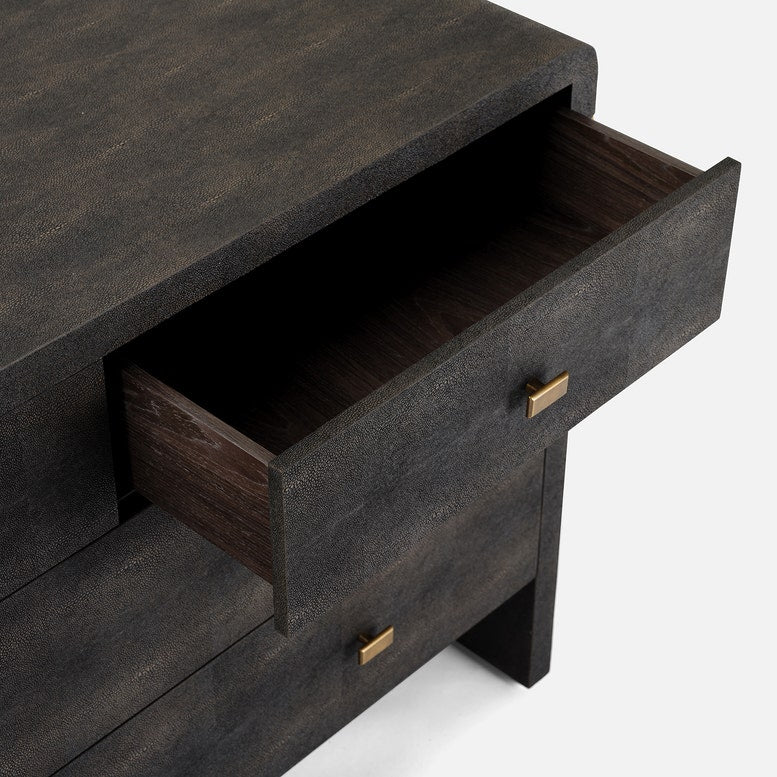A dark mushroom realistic faux shagreen chest of drawers with a textured finish, featuring five drawers and small brass pull handles, shown against a light gray background.