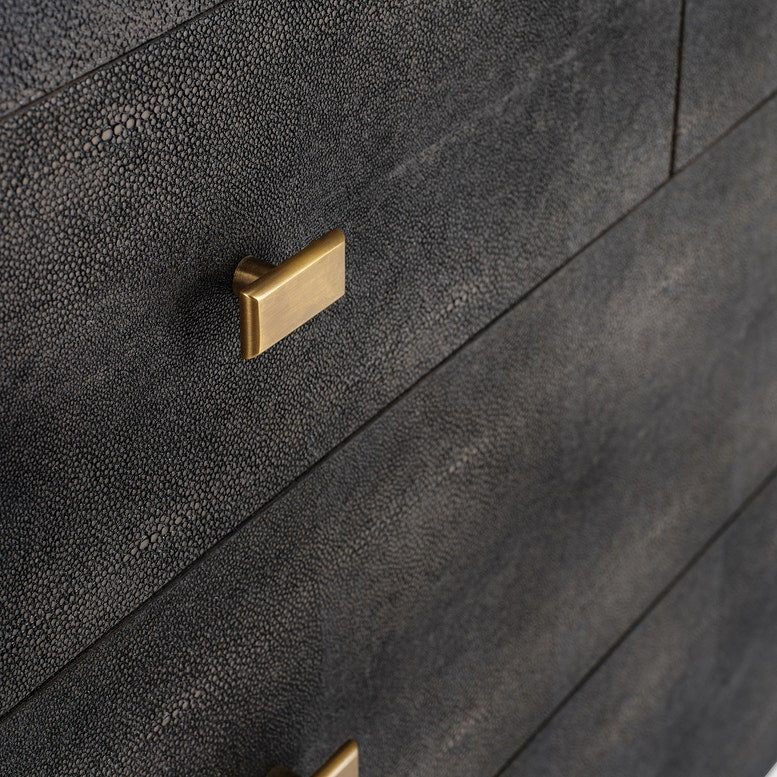 A dark mushroom realistic faux shagreen chest of drawers with a textured finish, featuring five drawers and small brass pull handles, shown against a light gray background.