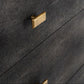 Close-up of a dark mushroom textured drawer with a rectangular gold pull handle, showing the fine grain pattern of the drawer front.
