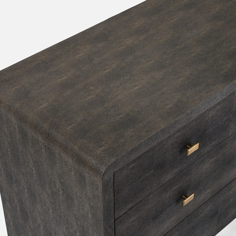 A dark mushroom realistic faux shagreen chest of drawers with a textured finish, featuring five drawers and small brass pull handles, shown against a light gray background.