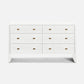 A white six-drawer dresser with small rectangular gold pull handles, shown against a plain white background.