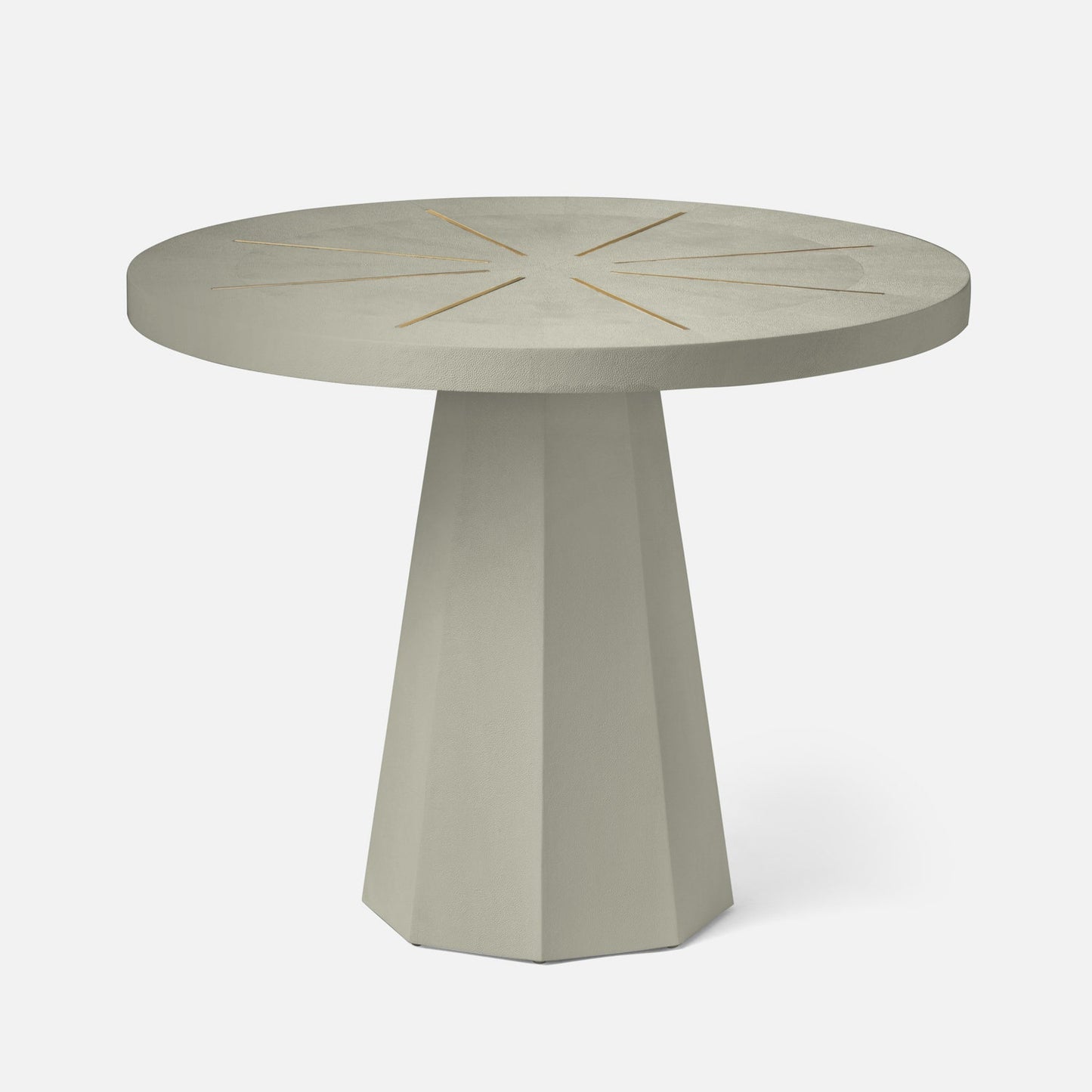 Round concrete table with starburst design on a white background
