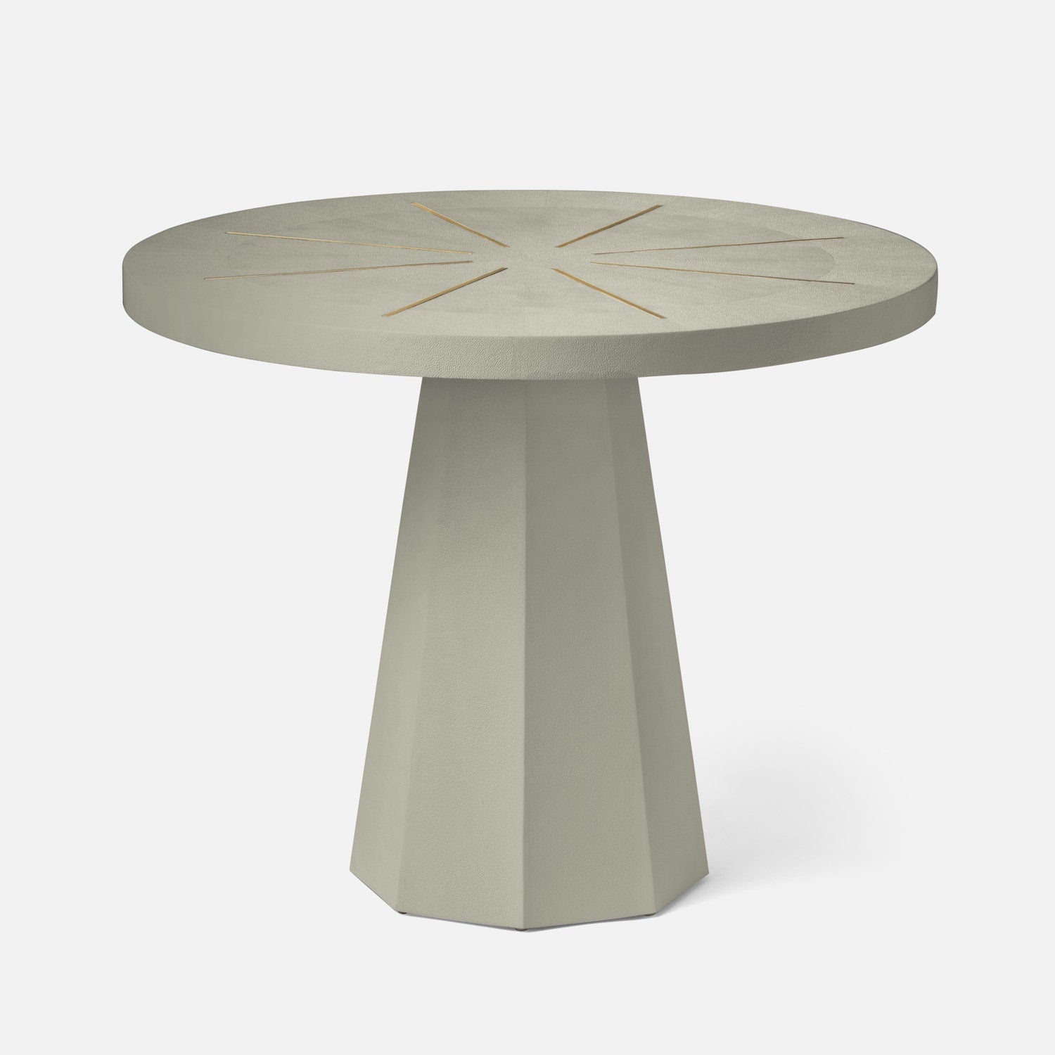 Round concrete table with starburst design on a white background