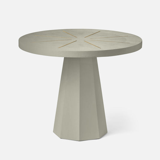 Round concrete table with starburst design on a white background