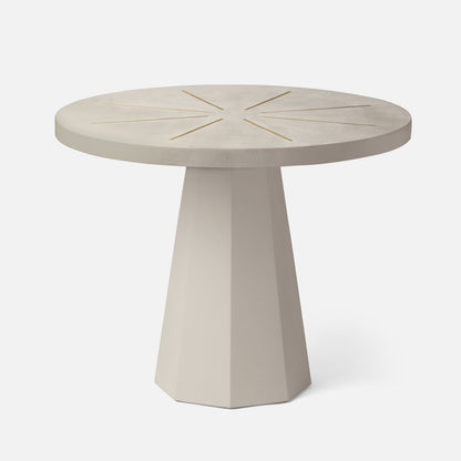 Round concrete table with star-like pattern on a white background