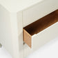 Close-up of a wooden drawer with a white frame on a light background