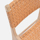 Close-up of a chair with woven backrest and seat on a white background