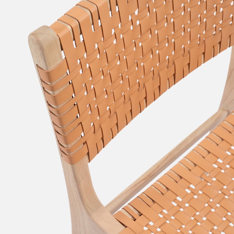 Close-up of a chair with woven backrest and seat on a white background