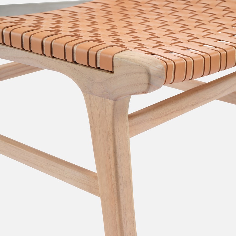 Wooden bench with woven seat on a white background