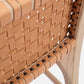 Close-up of a woven leather chair with wooden frame on a white background
