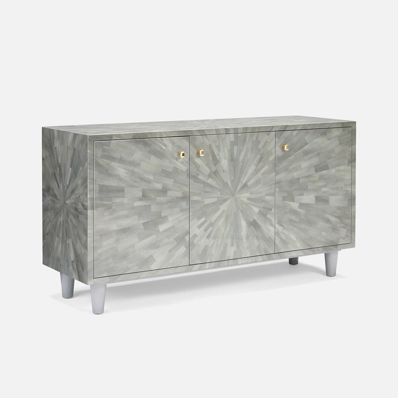 A modern sideboard cabinet featuring a gray and white geometric mosaic shell pattern on the doors and front, with small gold handles and tapered silver legs, shown against a light gray background.