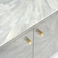 Close-up of a cabinet with gold handles on a light gray background