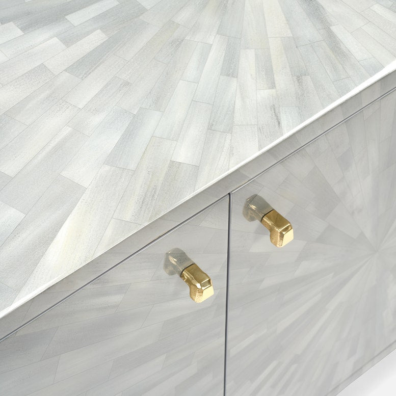 Close-up of a cabinet with gold handles on a light gray background
