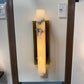 Wall-mounted light fixture with marble-like design on a glass panel