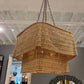 Woven pendant light hanging in a room with mirrors on the wall.